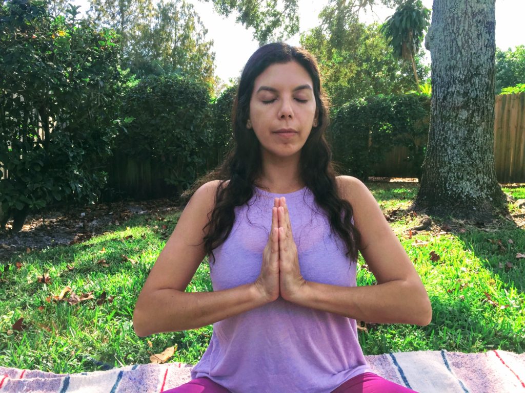 Palms in prayer mudra, thumbs to breast bone and chant OM. 